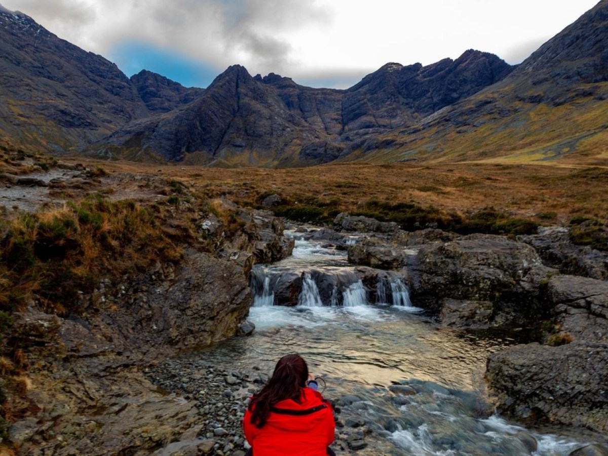 a person sitting on a rock