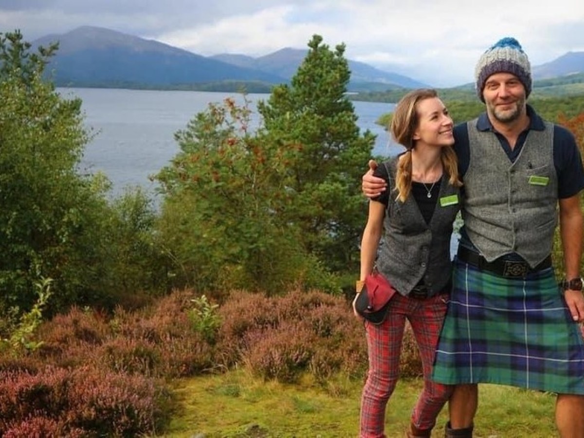 a man standing in front of a lake